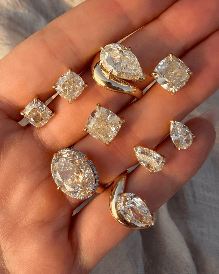 Hand wearing Logan Hollowell Jewelry diamond engagement rings