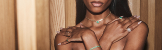 Close up of model neck wearing emerald necklace