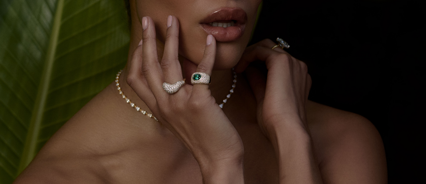 Close up of hands on check with LH rings on every finger