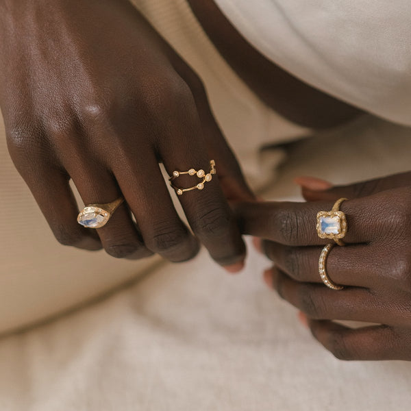 18k Queen Emerald Cut Moonstone Ring with Sprinkled Diamonds    by Logan Hollowell Jewelry